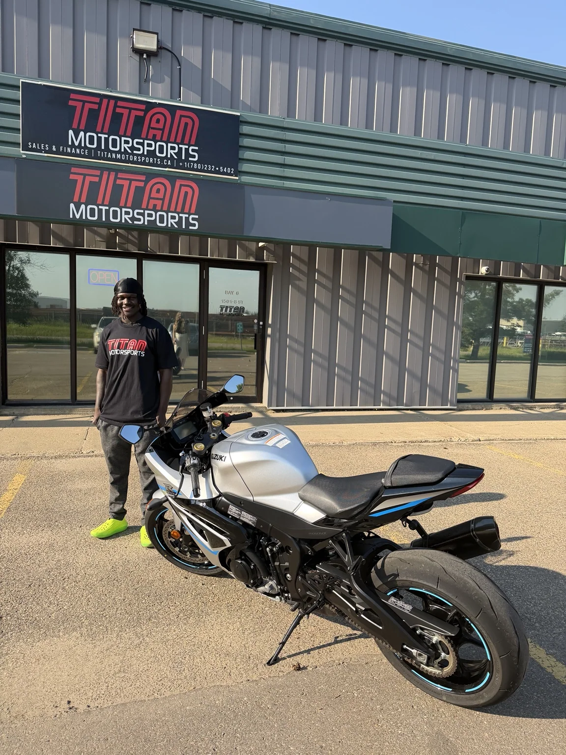 Customer beside a dirt bike at a previous dealership