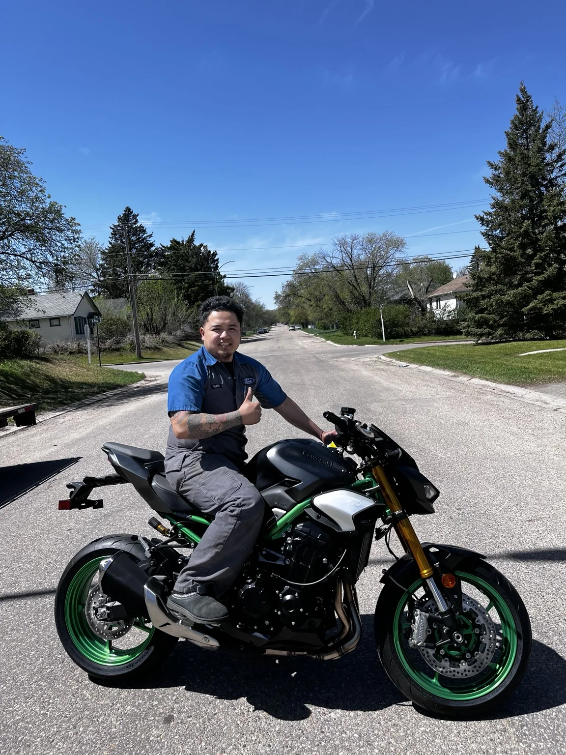 Rider seated on a motorcycle on a residential street