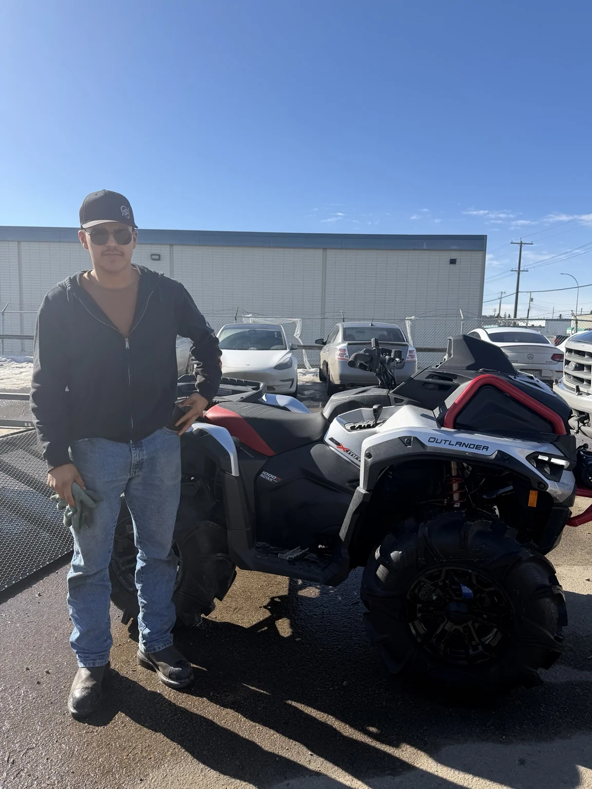 Customer standing beside an ATV