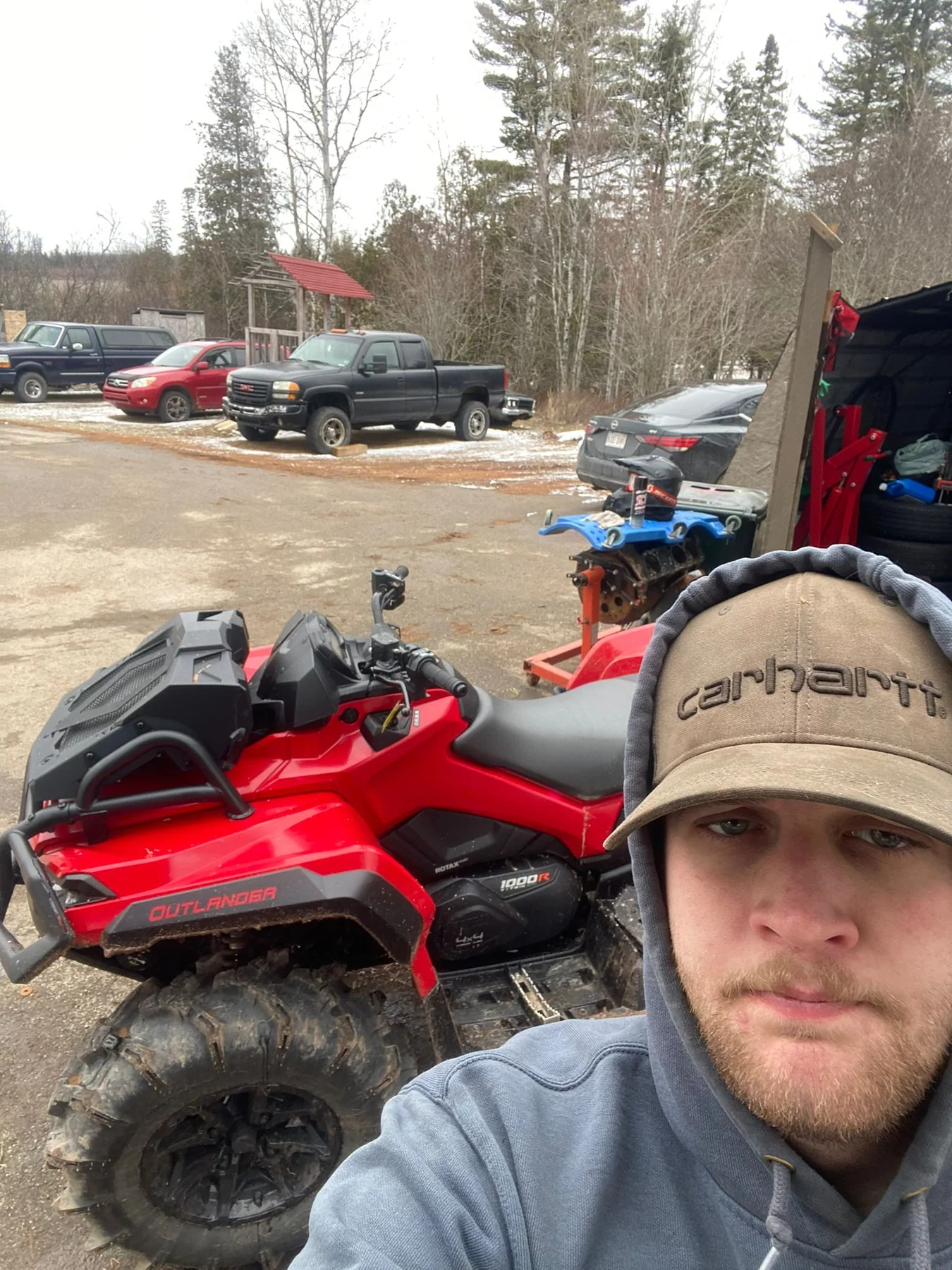Rider selfie beside an ATV
