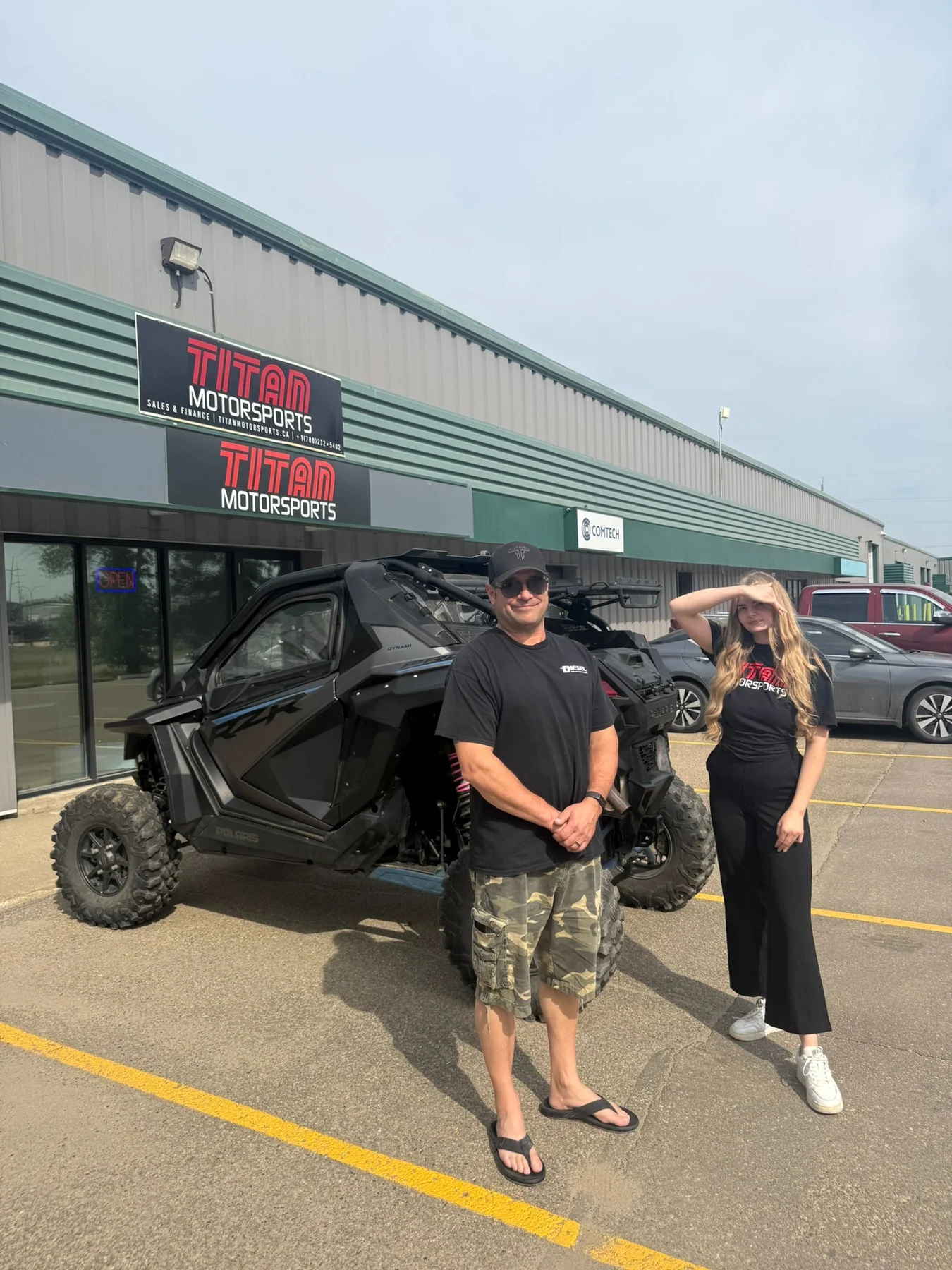 Customers beside a side-by-side outside a previous dealership