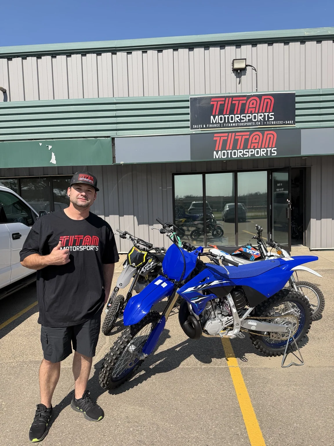Customer beside a dirt bike outside a previous dealership