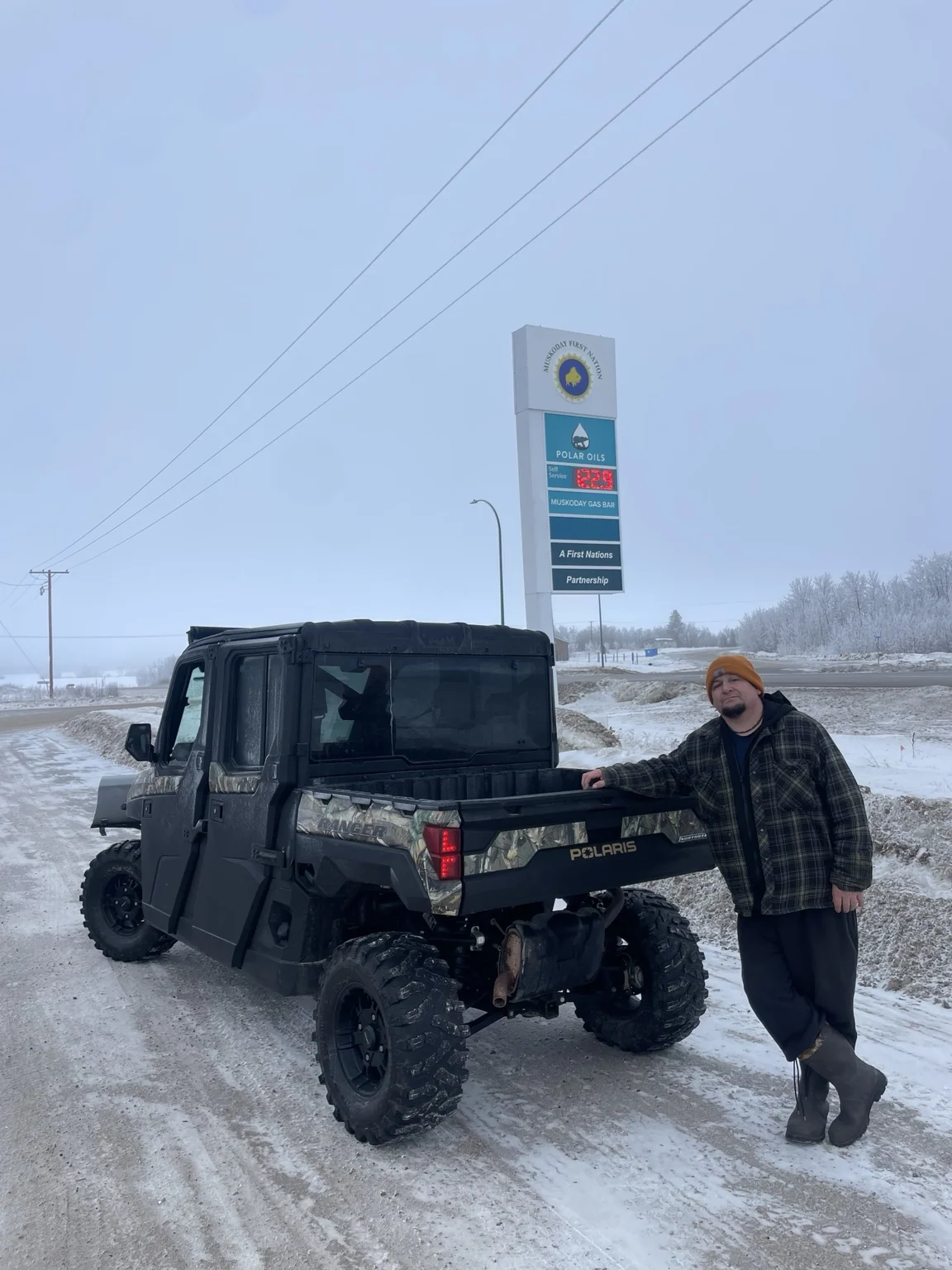 Customer beside a Polaris Ranger outdoors