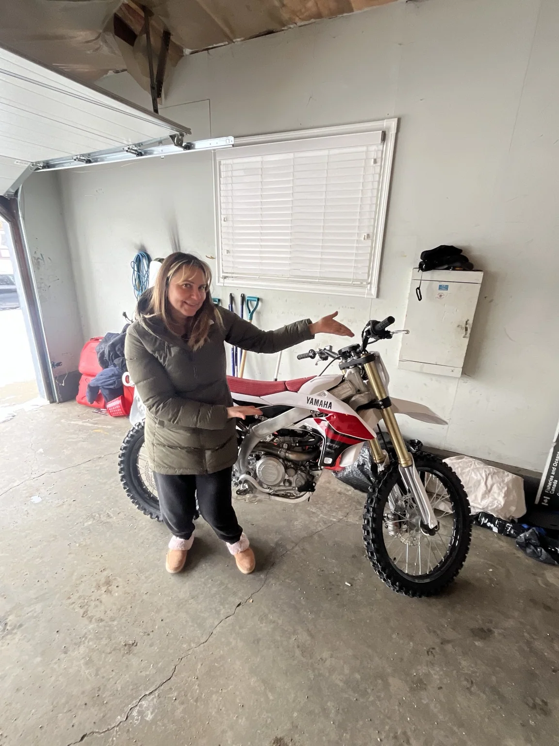 Customer with a dirt bike in a garage