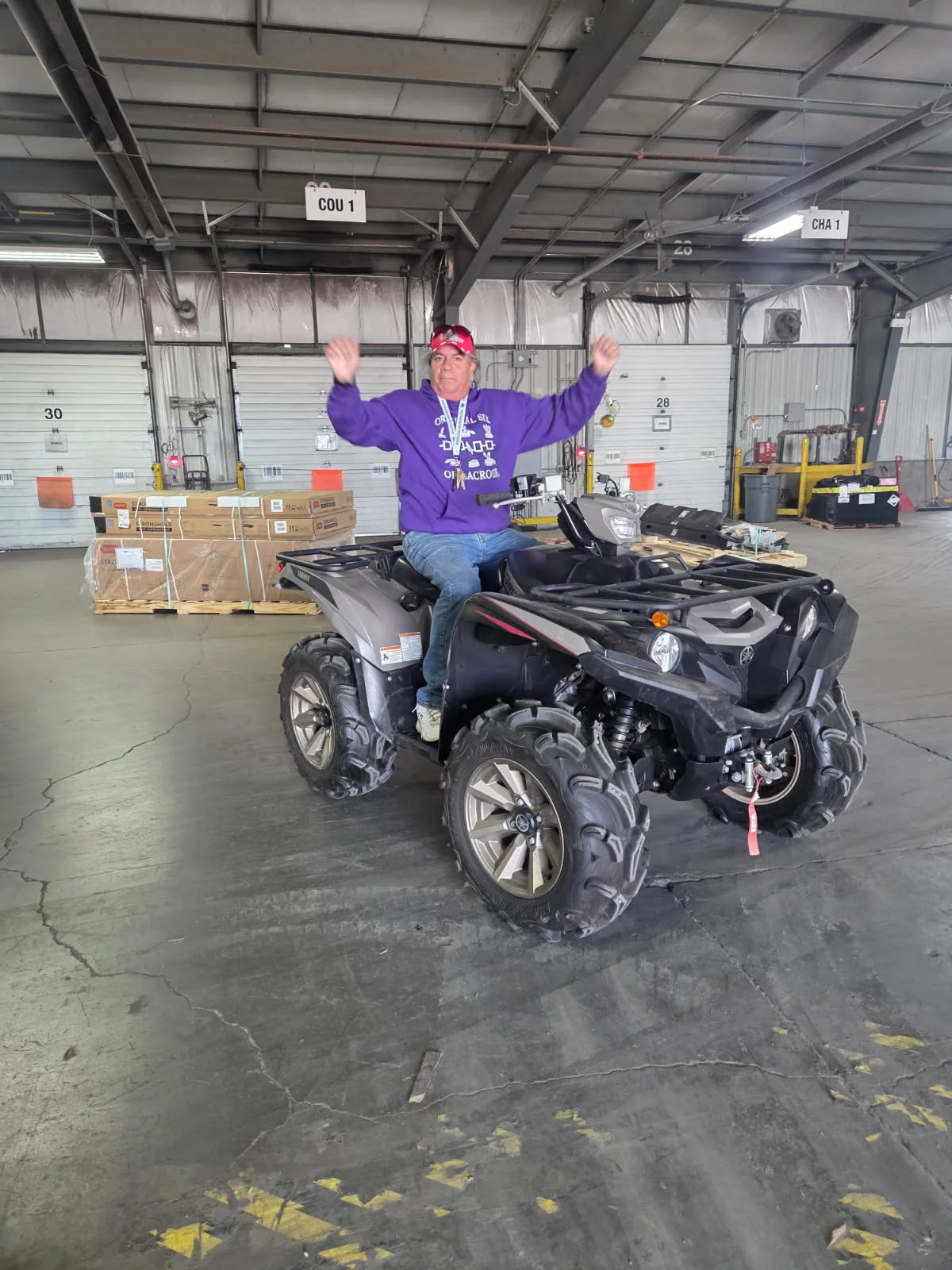 Customer celebrating while seated on an ATV indoors