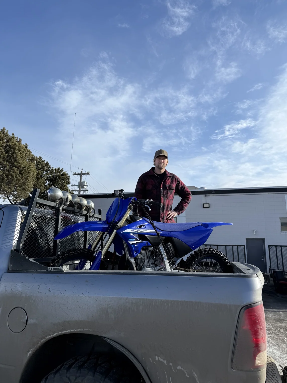 Customer with a dirt bike in a pickup truck