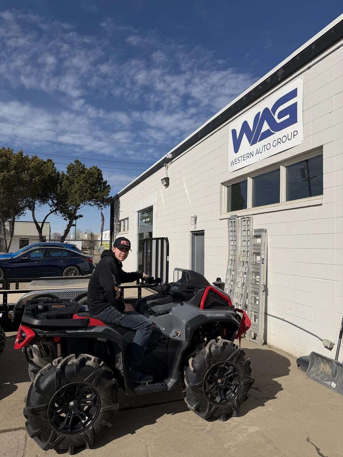 Customer with an ATV outside a previous dealership