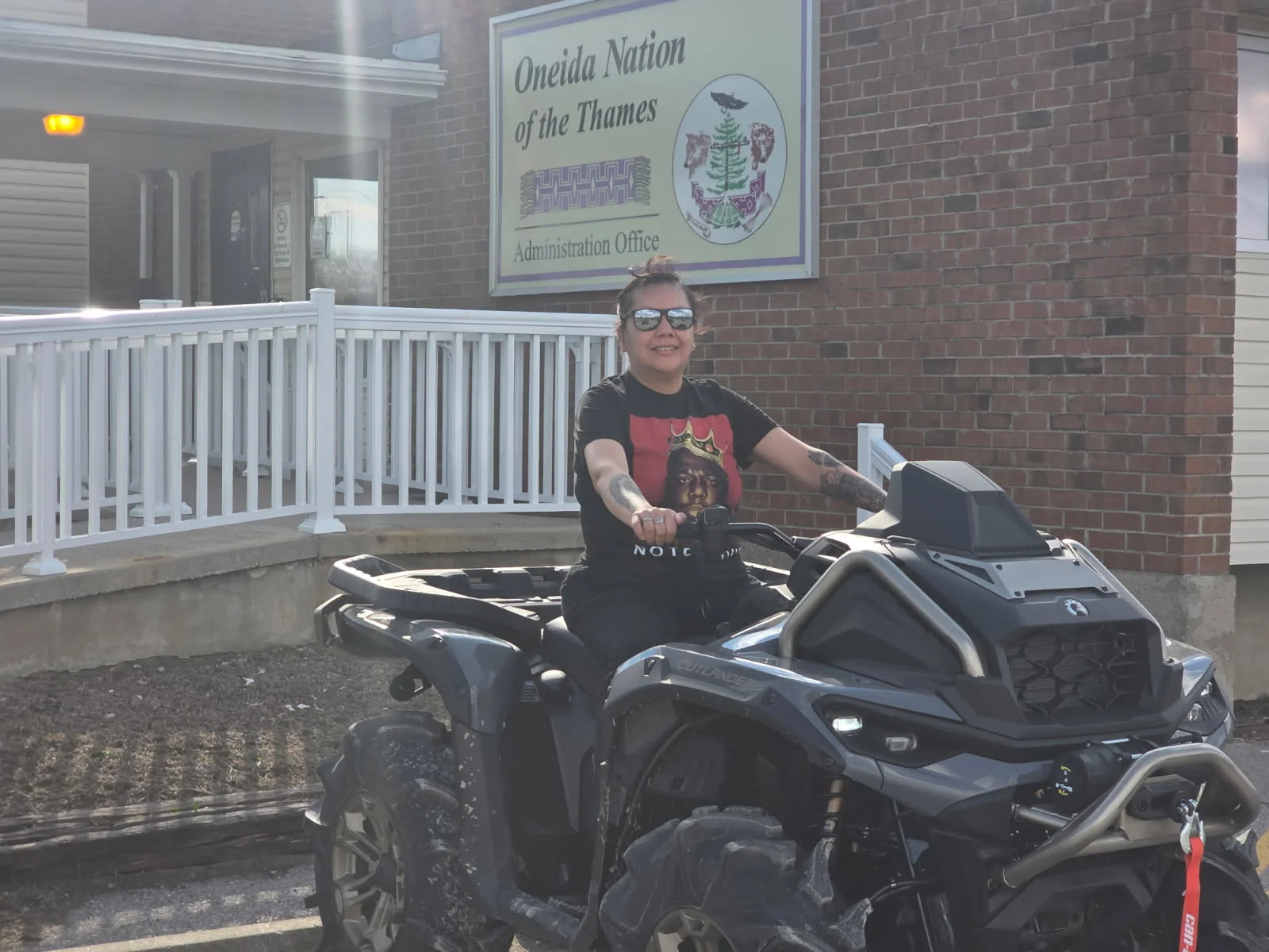 Customer seated on an ATV outside a community building